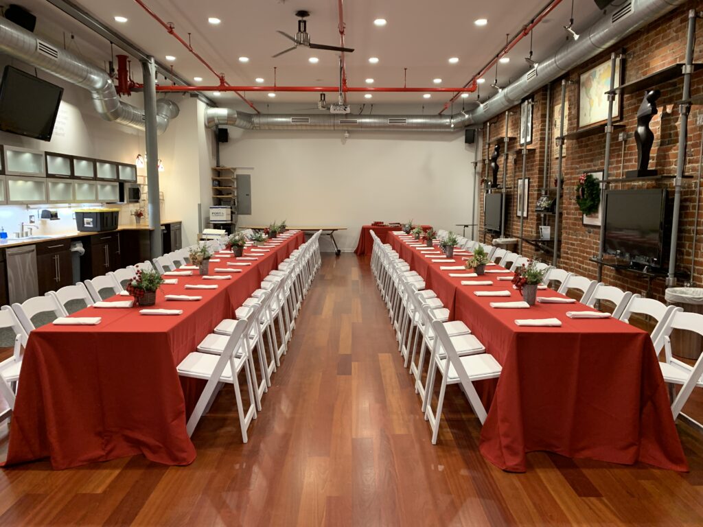 Banquet tables with white garden chairs setup for an event